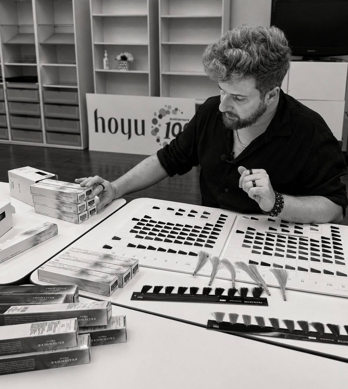Lucas Tamaio analyzing professional Asian hair color swatches and shade systems